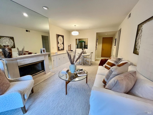 living room featuring a high end fireplace