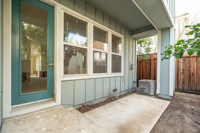 entrance to property with a patio and central air condition unit