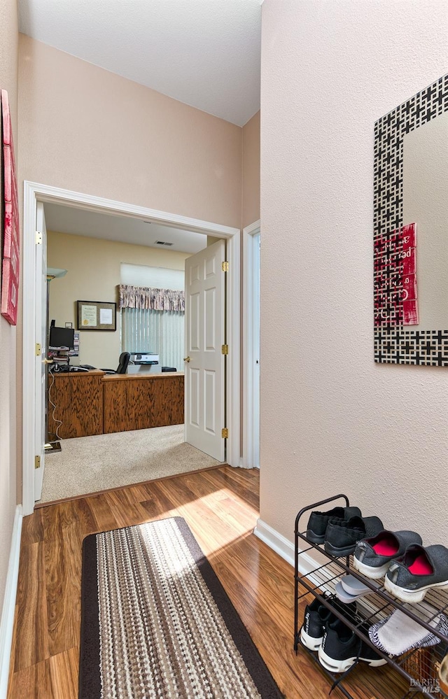 bathroom featuring baseboards and wood finished floors