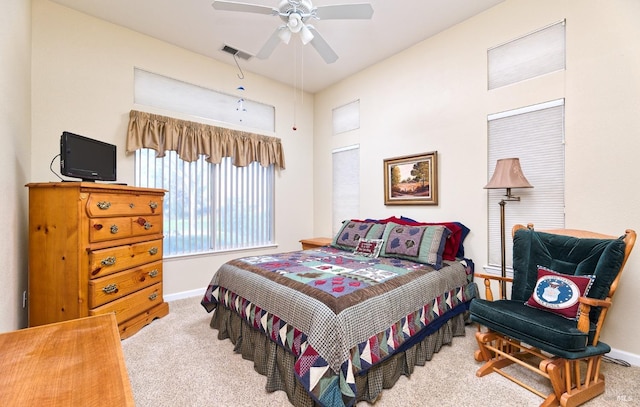 bedroom with carpet floors, baseboards, visible vents, and a ceiling fan