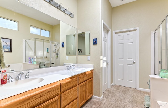 bathroom with a stall shower, a sink, baseboards, and double vanity