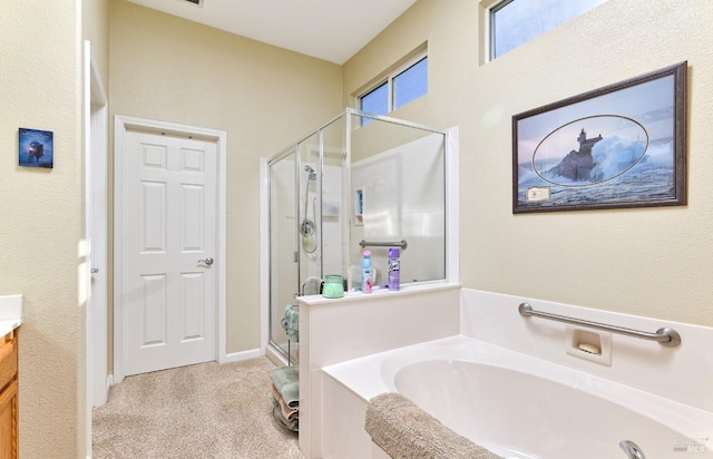 bathroom featuring a bath, a stall shower, and vanity