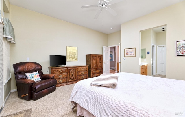 carpeted bedroom with ensuite bath and ceiling fan