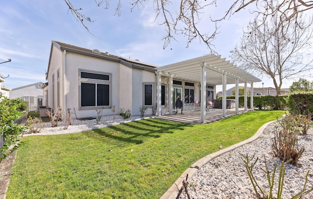 back of property featuring stucco siding, a yard, a pergola, and a patio