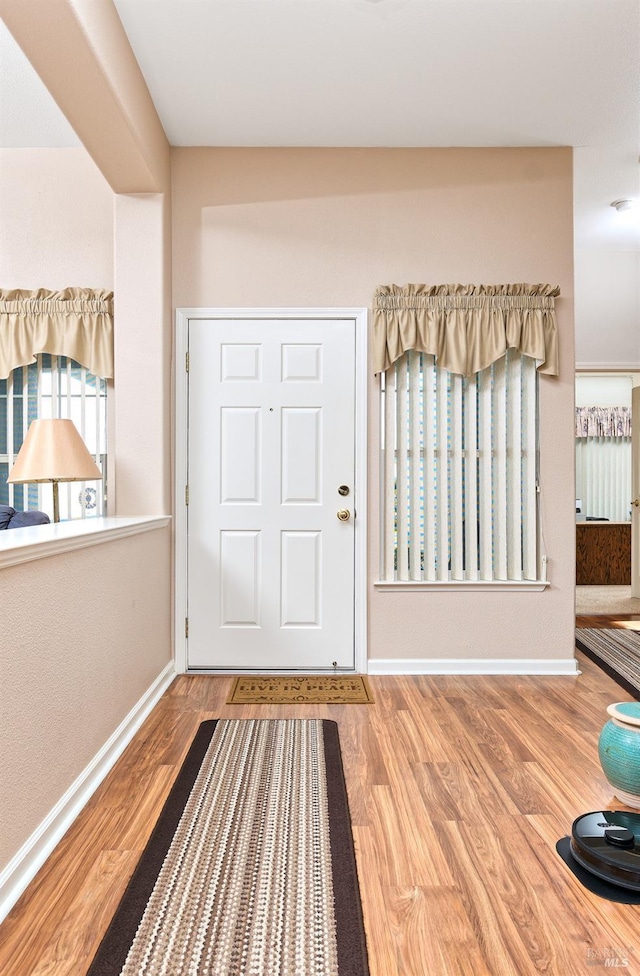 entrance foyer with wood finished floors and baseboards