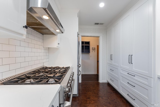 kitchen featuring light stone counters, white cabinetry, and exhaust hood