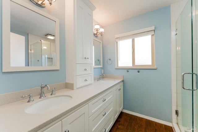 bathroom featuring walk in shower, wood-type flooring, and vanity