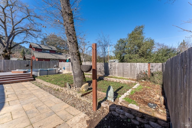 view of yard with a fenced in pool and a patio area