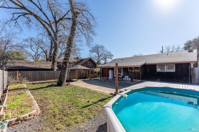 view of swimming pool with a patio area and a lawn