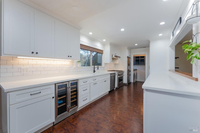 kitchen with wine cooler, white cabinetry, stainless steel appliances, and sink