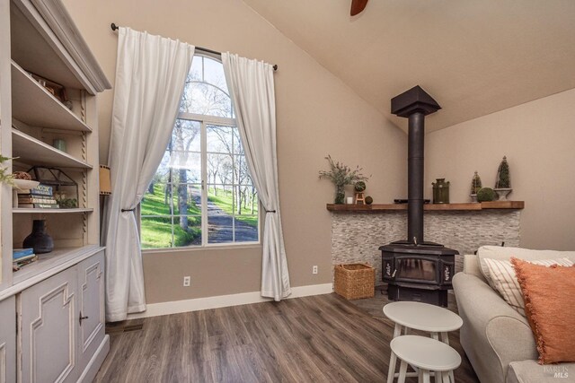 1061 Steele Canyon Rd, Napa, CA 94558 - sitting room with vaulted ceiling, plenty of natural light, dark wood-style floors, and a wood stove