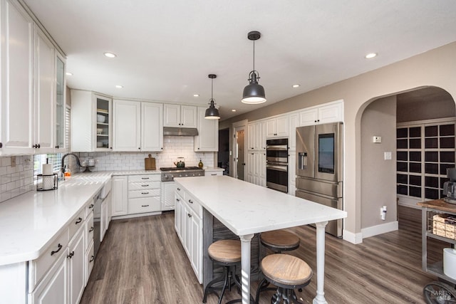 1061 Steele Canyon Rd, Napa, CA 94558 - kitchen with arched walkways, stainless steel appliances, and white cabinetry