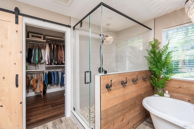 1061 Steele Canyon Rd, Napa, CA 94558 - full bath featuring wood finished floors, visible vents, a freestanding bath, a spacious closet, and a stall shower