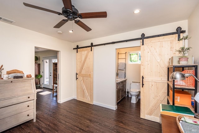 1061 Steele Canyon Rd, Napa, CA 94558 - bedroom featuring a barn door, dark wood-style flooring, visible vents, and baseboards