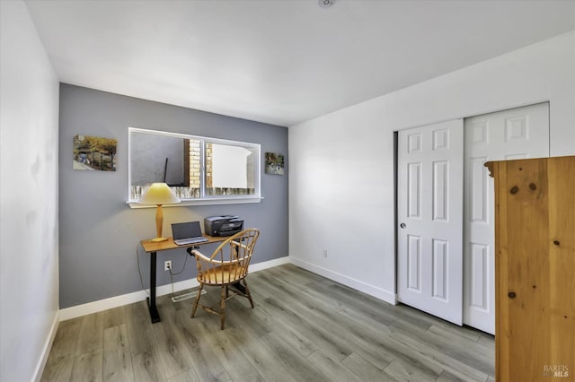 office with light hardwood / wood-style floors