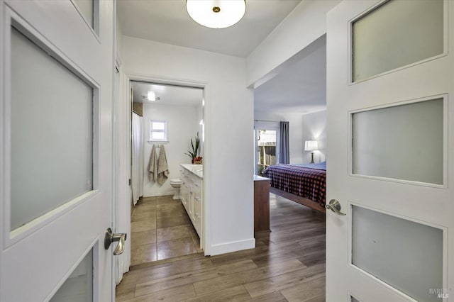 corridor featuring hardwood / wood-style flooring and a wealth of natural light