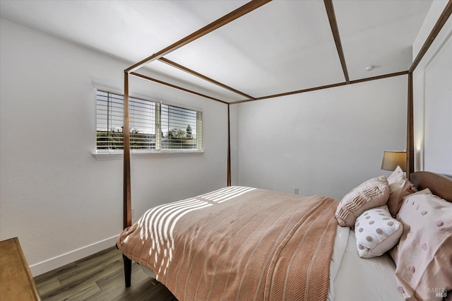 bedroom with dark wood-type flooring