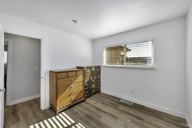 bedroom with dark wood-type flooring