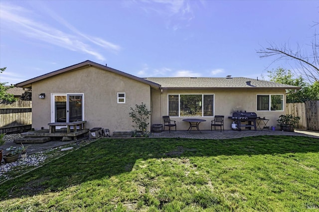 rear view of house featuring a patio and a lawn