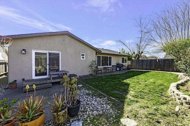 rear view of house with a patio area and a lawn