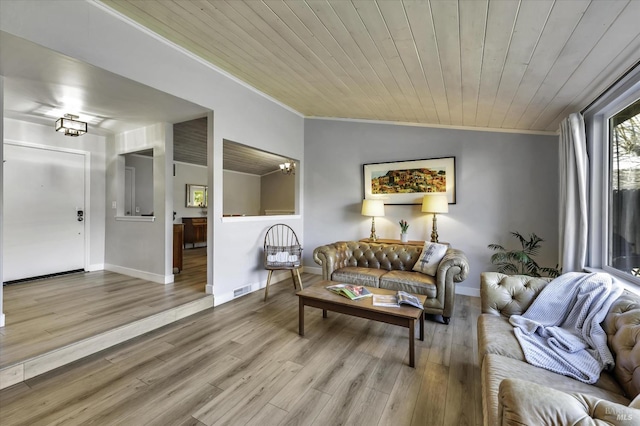 living room with wood ceiling, light hardwood / wood-style flooring, crown molding, an inviting chandelier, and vaulted ceiling