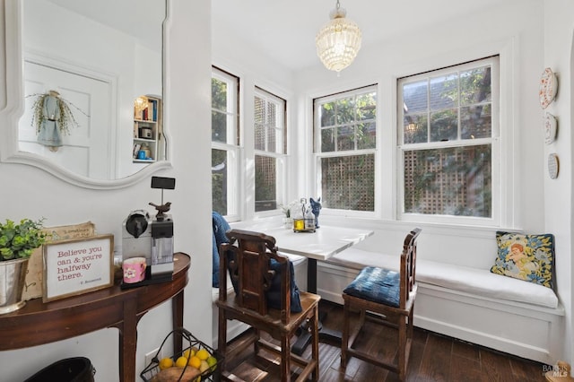 dining room featuring dark wood-type flooring, an inviting chandelier, and breakfast area