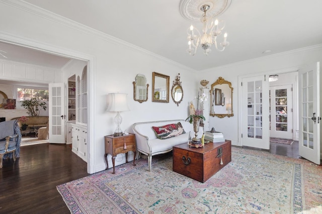 living room featuring an inviting chandelier, crown molding, dark wood-type flooring, and french doors