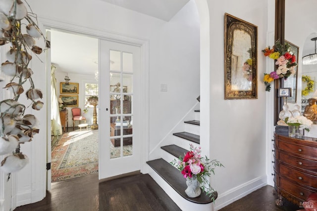 stairs with wood-type flooring and french doors