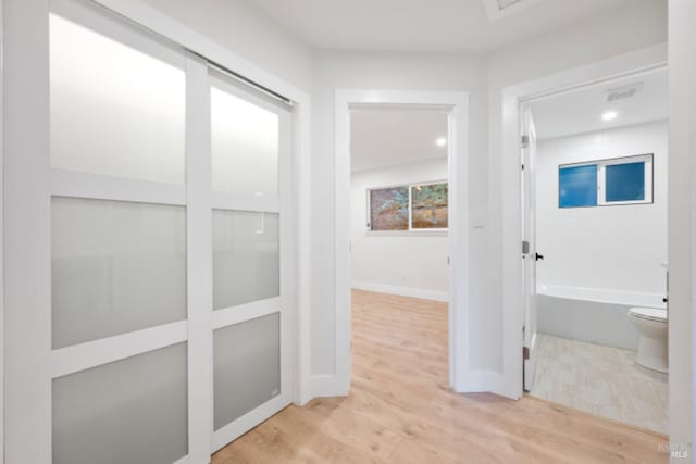 corridor featuring light hardwood / wood-style floors