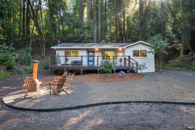 view of front of home with an outdoor fire pit and a deck