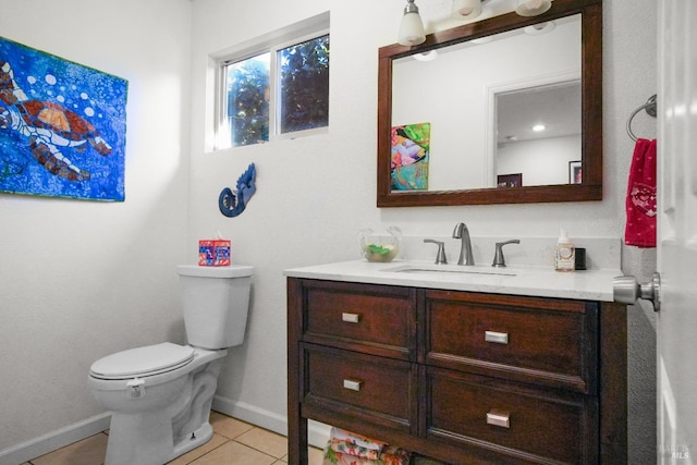 bathroom with tile patterned flooring, vanity, and toilet