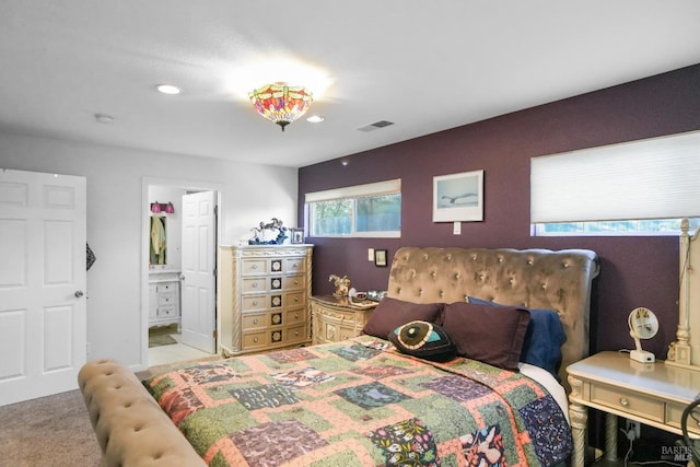 carpeted bedroom featuring connected bathroom