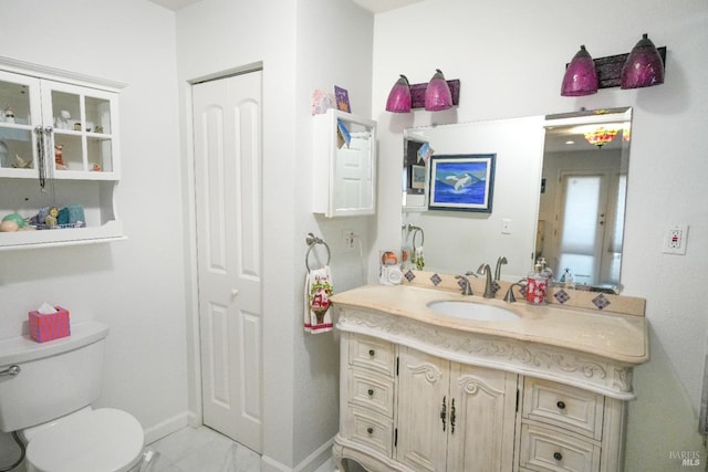 bathroom featuring vanity and toilet