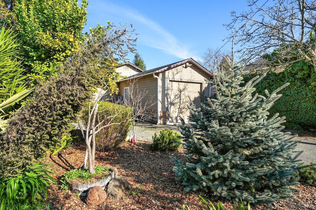 view of side of home featuring a storage unit