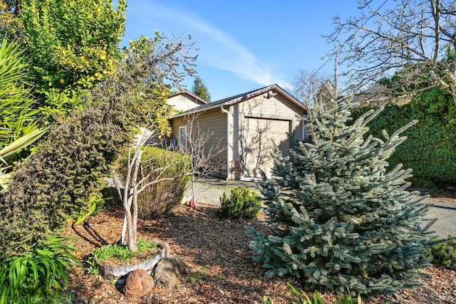 view of side of home featuring a storage unit