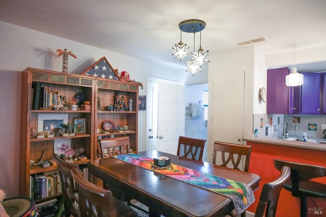 dining space featuring a textured ceiling