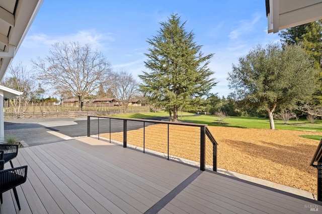 wooden terrace featuring a yard