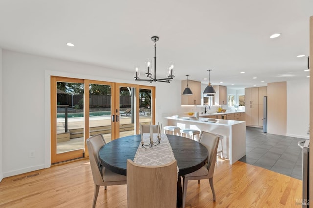 dining space featuring visible vents, plenty of natural light, and light wood-style flooring