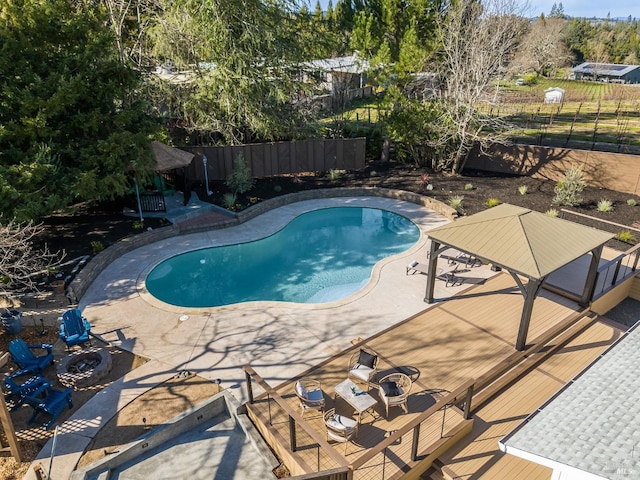 view of pool featuring a fenced in pool, a patio, a gazebo, a fenced backyard, and a fire pit