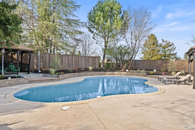 view of swimming pool featuring a fenced backyard, a patio, a fenced in pool, and a gazebo