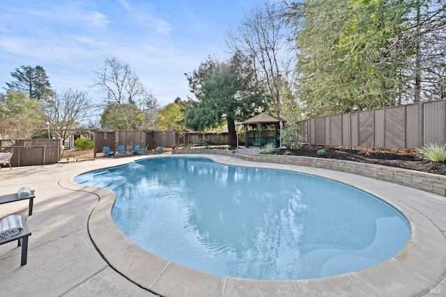 view of pool with a patio area, a fenced backyard, a fenced in pool, and a gazebo