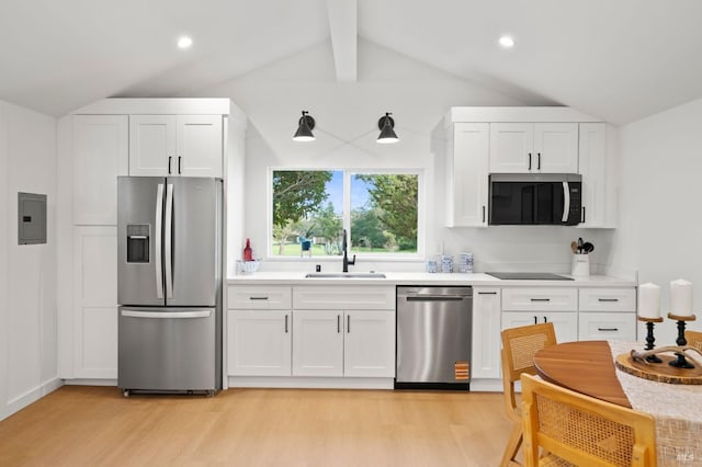 kitchen with stainless steel appliances, a sink, light countertops, and white cabinets