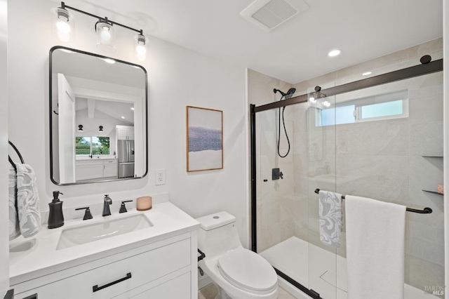 full bathroom with a stall shower, visible vents, vanity, and toilet