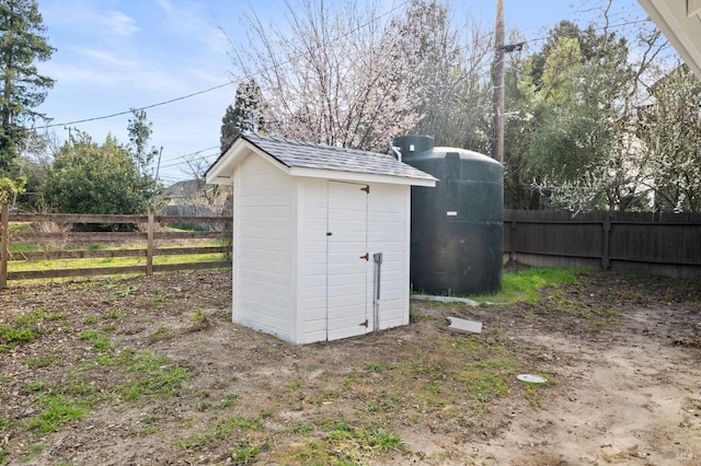 view of shed featuring fence