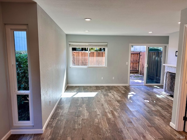 unfurnished living room with dark hardwood / wood-style floors