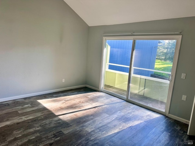 unfurnished room with dark wood-type flooring and vaulted ceiling