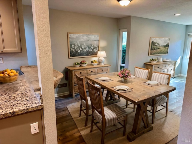 dining room with dark hardwood / wood-style flooring