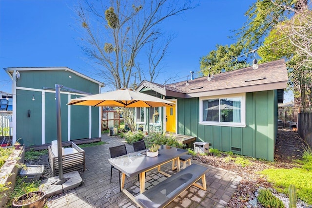 back of property featuring an outbuilding and a patio area