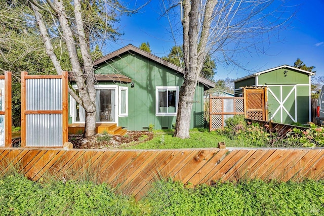 view of front of house featuring a storage unit