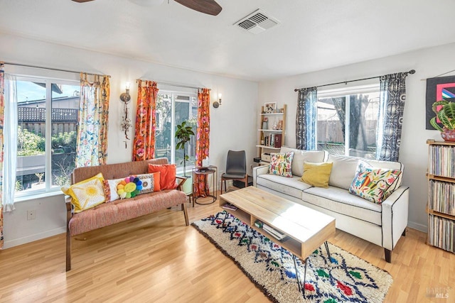 living room with ceiling fan and hardwood / wood-style floors